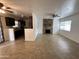 Living room with stone fireplace and open kitchen view at 269 Sylvan Rd, Wickenburg, AZ 85390