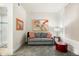 Cozy sitting area with gray sofa, red ottoman, and framed art at 8 Biltmore Estates Dr # 313, Phoenix, AZ 85016