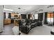 Open living room and kitchen with a large sectional sofa and island at 13164 W Ocotillo Ln, Surprise, AZ 85374