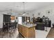Open concept kitchen and dining area with island, hardwood floors, and modern appliances at 13164 W Ocotillo Ln, Surprise, AZ 85374