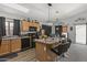 Modern kitchen with island, wood cabinets, and black appliances at 13164 W Ocotillo Ln, Surprise, AZ 85374