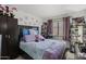 Bedroom with a bed, desk, and built-in shelving at 13164 W Ocotillo Ln, Surprise, AZ 85374