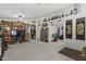 Living room featuring a large TV, built-in shelving, and hardwood floors at 13164 W Ocotillo Ln, Surprise, AZ 85374