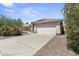 House exterior featuring a driveway and desert landscaping at 13164 W Ocotillo Ln, Surprise, AZ 85374