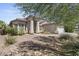 Single-story home with desert landscaping and a two-car garage at 13164 W Ocotillo Ln, Surprise, AZ 85374