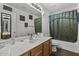 Clean bathroom with tub, shower, and wood vanity at 13164 W Ocotillo Ln, Surprise, AZ 85374