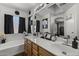 Bathroom with double sinks, bathtub, and shower at 13164 W Ocotillo Ln, Surprise, AZ 85374