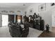 Spacious living room with built-in shelving, large TV, and comfortable leather seating at 13164 W Ocotillo Ln, Surprise, AZ 85374