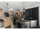 Kitchen with an island, light wood cabinets, and black appliances at 13164 W Ocotillo Ln, Surprise, AZ 85374