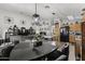 Kitchen with an island, light wood cabinets, and black appliances at 13164 W Ocotillo Ln, Surprise, AZ 85374