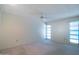 Spacious bedroom with ceiling fan and two windows at 15630 N Lakeforest Dr, Sun City, AZ 85351