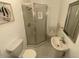 Small bathroom with shower, toilet and pedestal sink at 1517 W Sahuaro Dr, Phoenix, AZ 85029