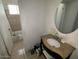 Clean bathroom with single vanity and bathtub shower combo at 1517 W Sahuaro Dr, Phoenix, AZ 85029