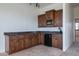Modern wet bar with dark wood cabinets and granite countertops at 40105 N 2Nd Way, Phoenix, AZ 85086