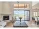 Bright living room with fireplace and sliding glass doors leading to a scenic view at 40105 N 2Nd Way, Phoenix, AZ 85086