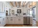 Open kitchen with island, stainless steel appliances and wood beam ceiling at 40105 N 2Nd Way, Phoenix, AZ 85086