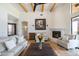 Spacious living room with a fireplace, exposed beams, and comfortable seating at 40105 N 2Nd Way, Phoenix, AZ 85086