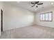 Spacious bedroom with ceiling fan, large window with plantation shutters, and neutral carpeting at 40105 N 2Nd Way, Phoenix, AZ 85086