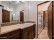 Spa-like bathroom featuring a double vanity, chandelier, and a glass-enclosed shower at 40105 N 2Nd Way, Phoenix, AZ 85086