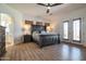 Spacious bedroom with dark wood furniture and French doors leading to backyard at 40105 N 2Nd Way, Phoenix, AZ 85086