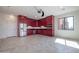 Modern kitchen features red cabinetry, stainless steel appliances, and tile flooring at 40105 N 2Nd Way, Phoenix, AZ 85086