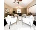 Bright living room with white armchairs and a round ottoman at 1311 S Ponderosa Dr, Gilbert, AZ 85296