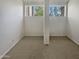 Well-lit bedroom with two windows and neutral colored carpet at 14002 N 49Th Ave # 1074, Glendale, AZ 85306