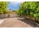 Landscaped backyard with a curved stone bench and mature trees at 7240 N Dreamy Draw Dr # 113, Phoenix, AZ 85020