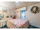 Bright bedroom with floral bedding and access to a private balcony at 7240 N Dreamy Draw Dr # 113, Phoenix, AZ 85020