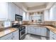 Galley kitchen with granite countertops and white cabinets at 7240 N Dreamy Draw Dr # 113, Phoenix, AZ 85020