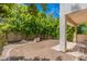 Private backyard with a stone seating area and mature trees at 7240 N Dreamy Draw Dr # 113, Phoenix, AZ 85020
