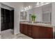 Double vanity bathroom with dark wood cabinets and tiled shower at 3407 E Glacier Pl, Chandler, AZ 85249