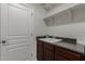 Laundry room with utility sink and shelving at 3407 E Glacier Pl, Chandler, AZ 85249