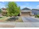 House exterior showcasing a two-car garage and manicured lawn at 3058 E Spring Wheat Ln, Gilbert, AZ 85296