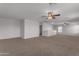 Open loft space with neutral walls, carpet, and ceiling fans at 22706 N 17Th St, Phoenix, AZ 85024