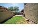 Small grassy backyard with a patio and block wall at 7351 W Palo Brea Ln, Peoria, AZ 85383