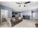 Living room with tile floors and dark brown couch at 1080 W Paradise Pl, Casa Grande, AZ 85122