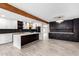 Modern kitchen with large island, marble countertops, and dark cabinetry at 1236 E Mclellan Blvd, Phoenix, AZ 85014