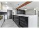 Open concept kitchen with large island, black cabinets, and marble countertops at 1236 E Mclellan Blvd, Phoenix, AZ 85014