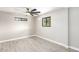 Bright bedroom with ceiling fan, wood-look tile floors, and large window at 1236 E Mclellan Blvd, Phoenix, AZ 85014