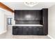 Modern kitchen with dark cabinetry and marble countertops at 1236 E Mclellan Blvd, Phoenix, AZ 85014
