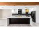 Modern kitchen with white and black cabinets, marble countertops, and gold accents at 1236 E Mclellan Blvd, Phoenix, AZ 85014