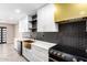 Renovated kitchen with white cabinets, gold range hood, and a copper farmhouse sink at 1236 E Mclellan Blvd, Phoenix, AZ 85014