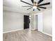 Bright bedroom with ceiling fan, wood-look tile floor, and large closet at 1236 E Mclellan Blvd, Phoenix, AZ 85014