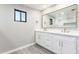 Modern bathroom with double vanity, white cabinets, and a gold-trimmed shower at 1236 E Mclellan Blvd, Phoenix, AZ 85014