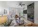 Spacious living room featuring a stone fireplace and comfortable seating at 6900 E Princess Dr # 2221, Phoenix, AZ 85054