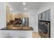 Efficient kitchen with stainless steel appliances and laundry area at 6900 E Princess Dr # 2221, Phoenix, AZ 85054