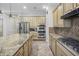 Kitchen with stainless steel appliances and granite island at 3051 W Sousa Ct, Anthem, AZ 85086