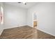 Well-lit bedroom featuring wood-look tile flooring and an ensuite bathroom at 3051 W Sousa Ct, Anthem, AZ 85086