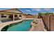 Inviting backyard with a sparkling pool and a rock waterfall feature at 30629 N Royal Oak Way, San Tan Valley, AZ 85143